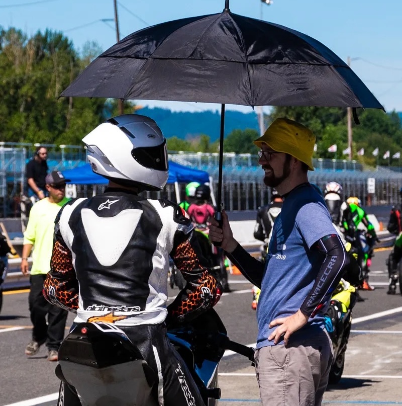Colin Carihill standing with his motorcycle